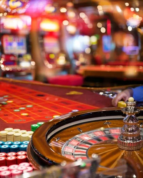 Roulette wheel and betting table with chip stacks