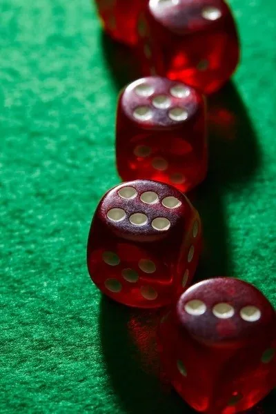 Row of red dice on green felt