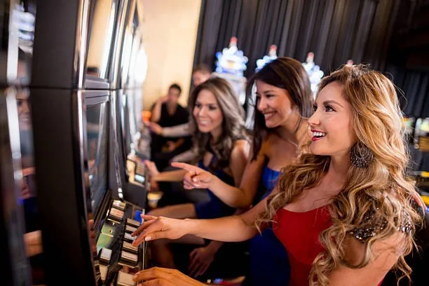Smiling players at a row of slot machines
